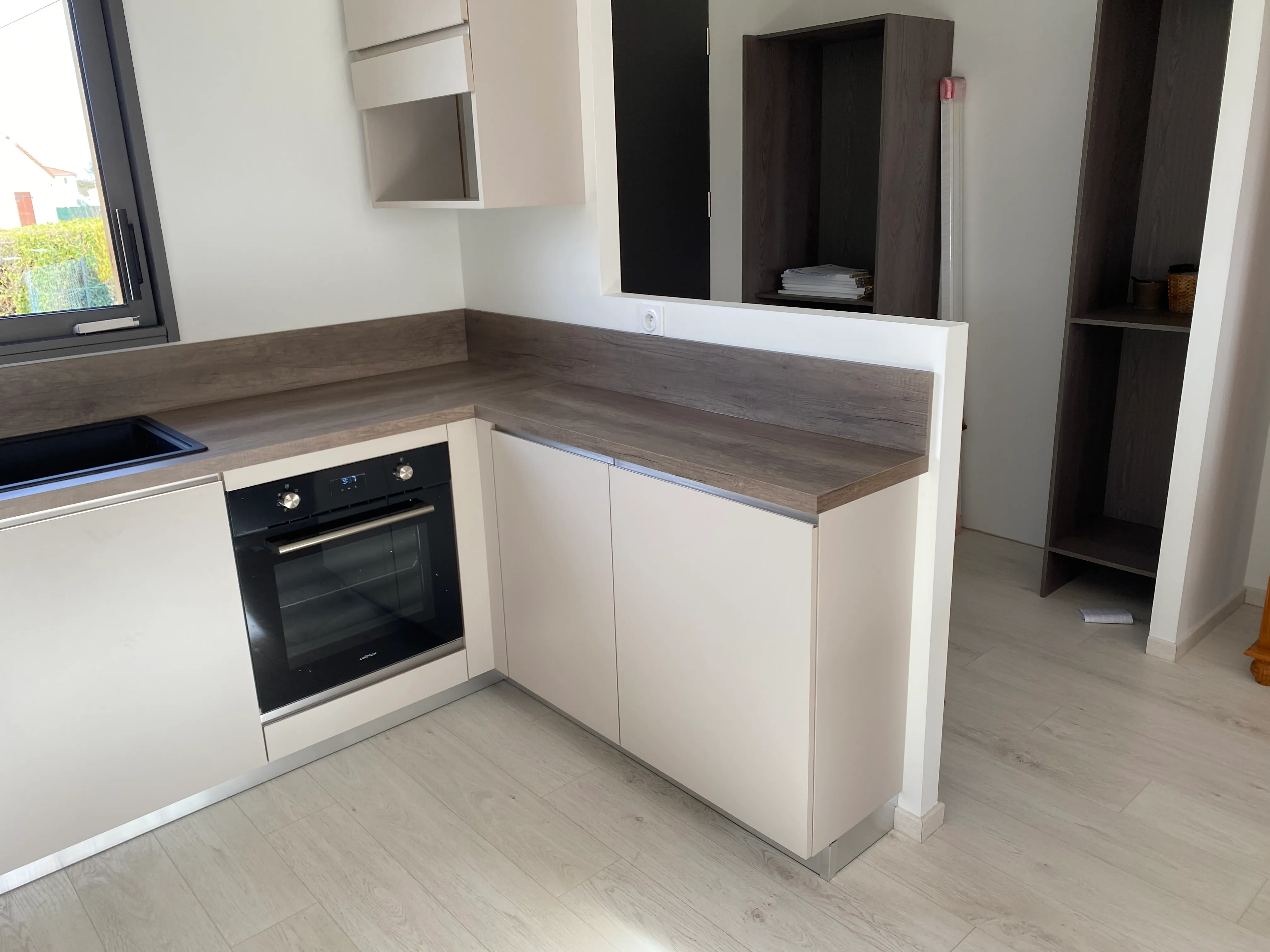 Cuisine crème — vue rapprochée mettant en valeur la laque satinée et le plan Dekton