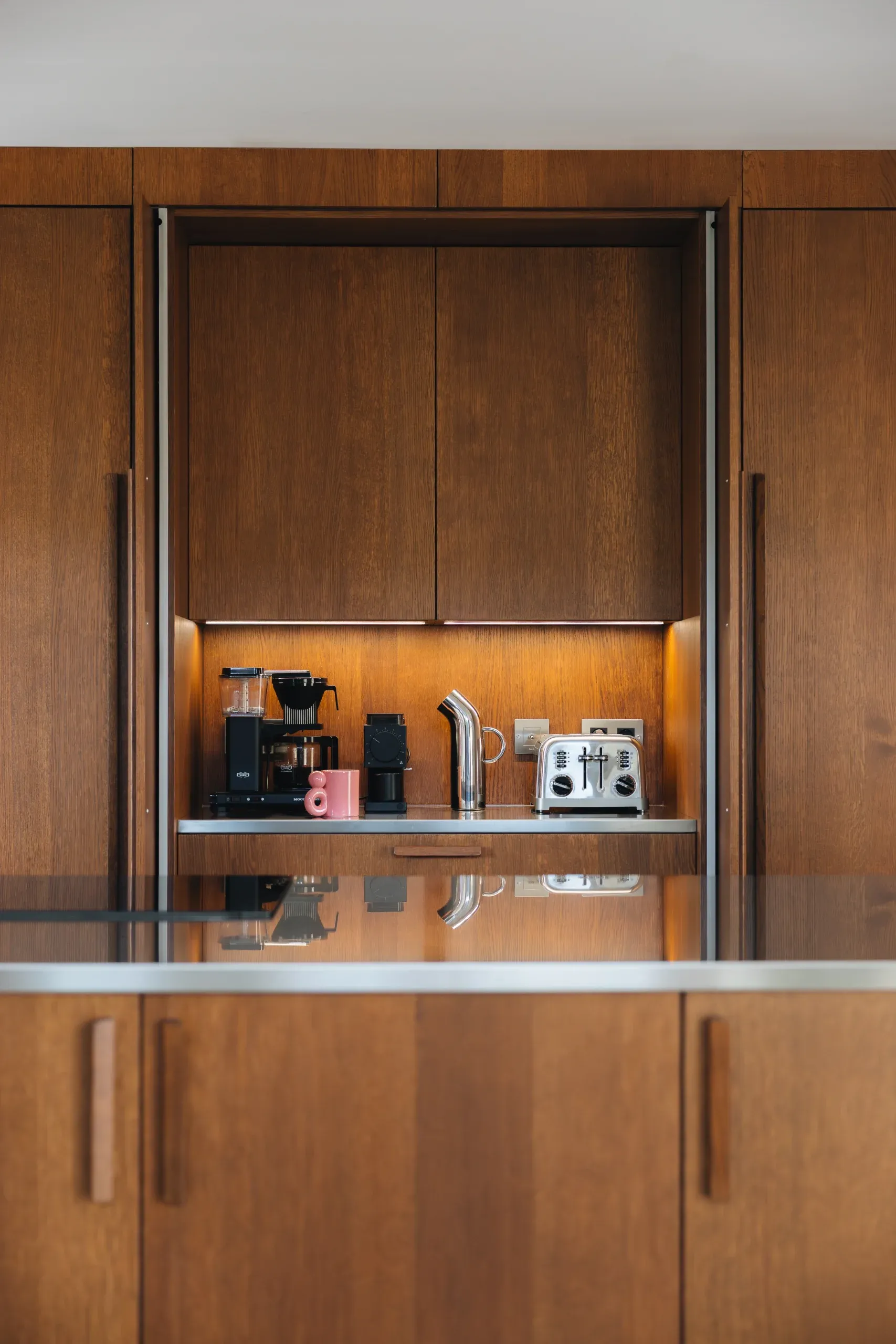 Coffee bar caché derrière des portes escamotables — machines à café et grille-pain en rangement intégré